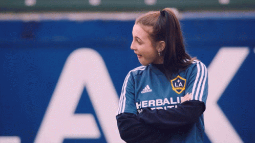 A Woman Wearing A Blue Shirt That Says Herbalife GIF