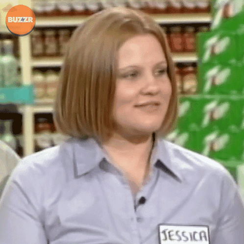A Woman Wearing A Blue Shirt With A Name Tag That Says Jessica GIF