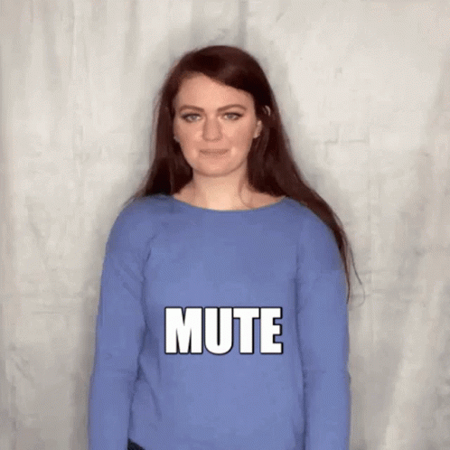 A Woman Wearing A Blue Sweater Is Making A Mute Sign . GIF