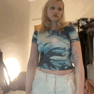 A Woman Wearing A Blue Tie Dye Crop Top And White Pants GIF
