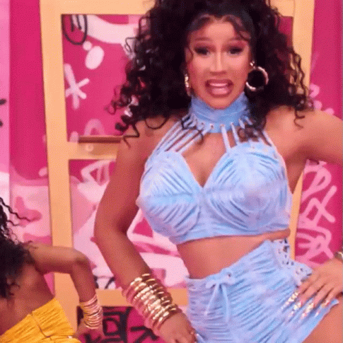 A Woman Wearing A Blue Top And Shorts Is Dancing GIF