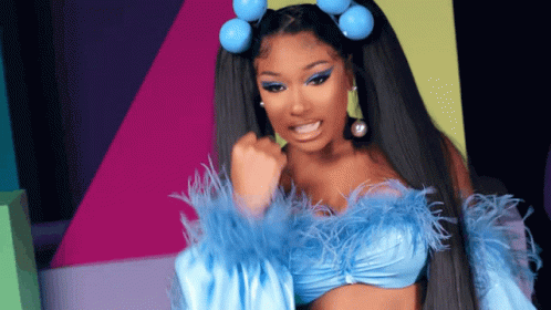a woman wearing a blue top with feathers and blue hair rollers
