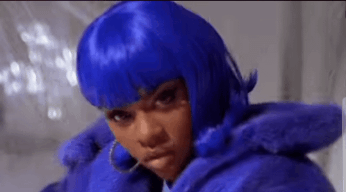 A Woman Wearing A Blue Wig And A Blue Fur Coat Is Making A Funny Face . GIF