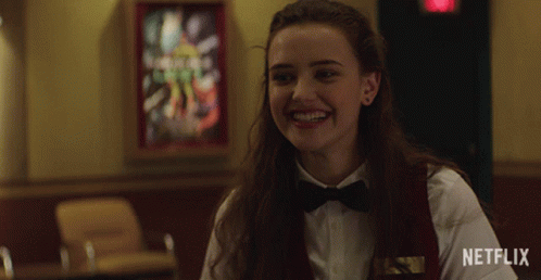 a woman wearing a bow tie is smiling in front of a netflix logo