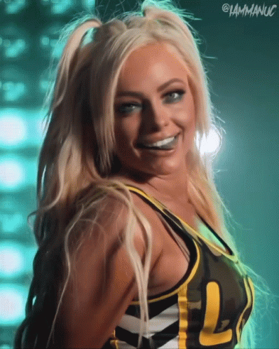 A Woman Wearing A Camo Top With The Letters L On It GIF