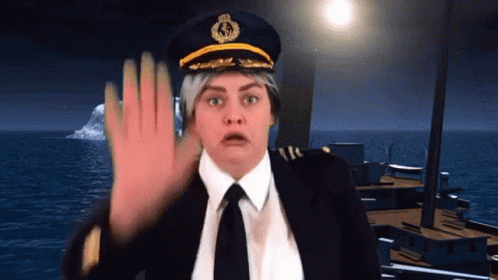 A Woman Wearing A Captain 'S Hat And Tie Is Making A Stop Sign GIF