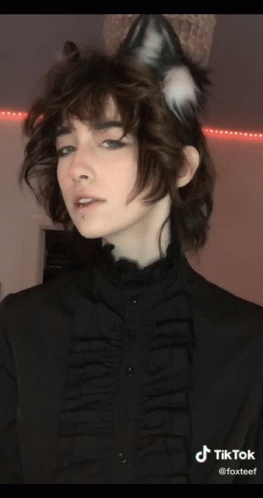 A Woman Wearing A Cat Ear Headband And A Black Shirt With Tiktok Written On The Bottom Right GIF