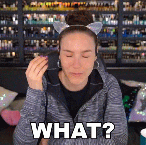 a woman wearing a cat ear headband is asking what