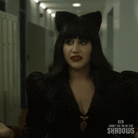 A Woman Wearing A Cat Ear Wig From Fx 'S What We Do In The Shadows Is Making A Funny Face GIF