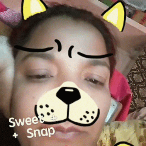 A Woman Wearing A Cat Face Mask With The Words Sweet Snap Written On The Bottom GIF