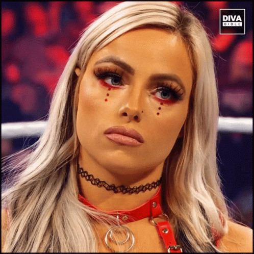 A Woman Wearing A Choker And Red Eye Shadow Is Featured In A Diva Girls Ad GIF