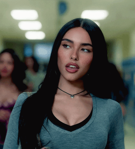 A Woman Wearing A Choker Necklace And A Gray Shirt GIF