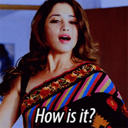 A Woman Wearing A Colorful Striped Saree Is Asking " How Is It " GIF