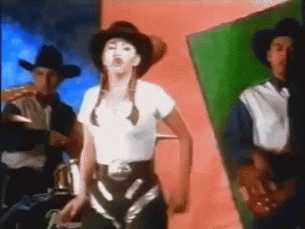 a woman wearing a cowboy hat is dancing with two men