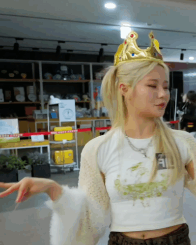 A Woman Wearing A Crown And A White Crop Top GIF