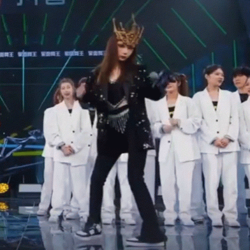 A Woman Wearing A Crown Is Dancing On A Stage GIF