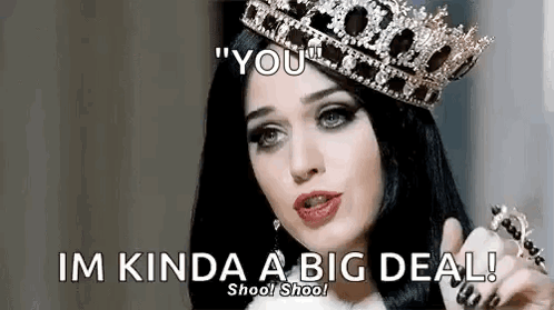 A Woman Wearing A Crown Is Pointing At The Camera And Saying `` You '' . GIF