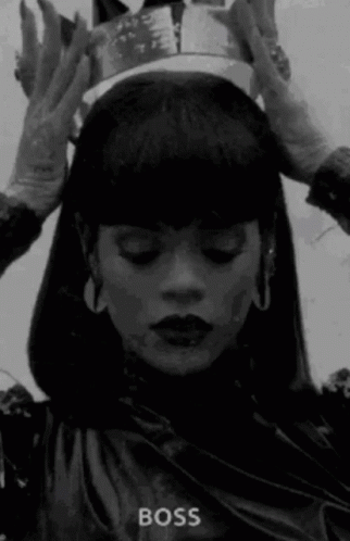 A Woman Wearing A Crown On Her Head In A Black And White Photo . GIF
