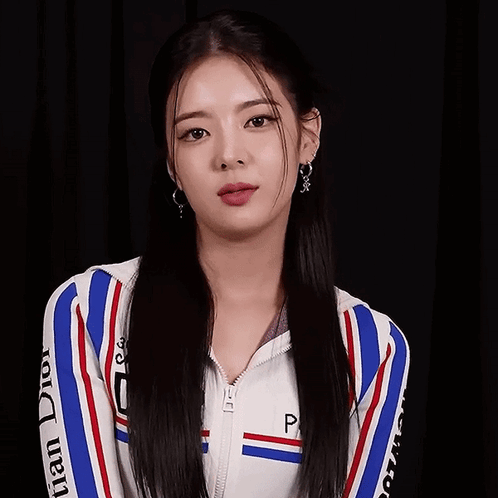A Woman Wearing A Dior Jacket And Earrings GIF