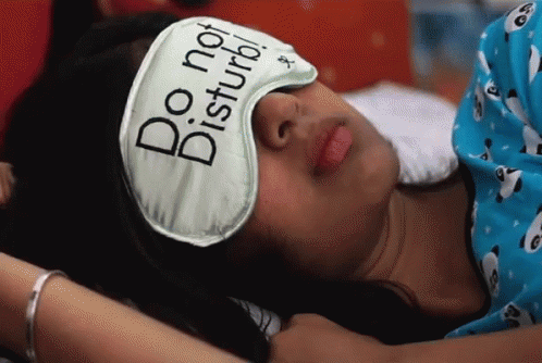 A Woman Wearing A Do Not Disturb Sleep Mask GIF