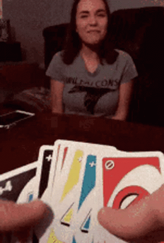 A Woman Wearing A Falcons Shirt Sits At A Table With Cards GIF
