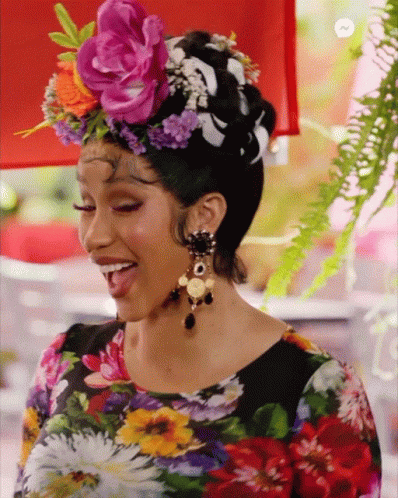 A Woman Wearing A Floral Shirt And A Flower Crown On Her Head GIF