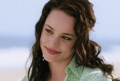 A Woman Wearing A Green And White Checkered Shirt Smiles For The Camera GIF