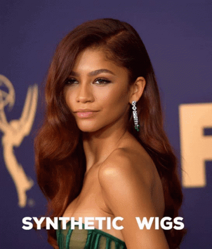 A Woman Wearing A Green Dress With Synthetic Wigs Written Below Her GIF