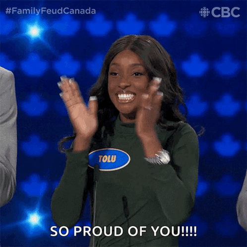 A Woman Wearing A Green Sweater With The Name Tolu On It Applauds GIF