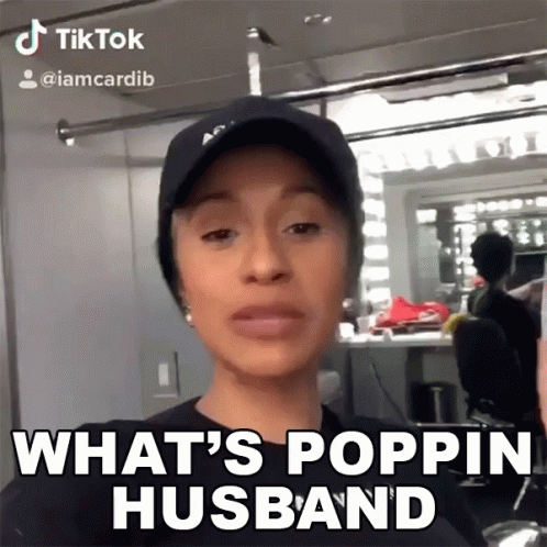 A Woman Wearing A Hat And A Black Shirt Says What 'S Poppin Husband GIF