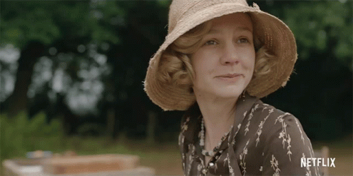 A Woman Wearing A Hat And A Shirt With Netflix Written On It GIF