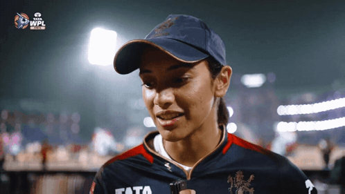 A Woman Wearing A Hat And A Shirt With The Word Tata On It GIF