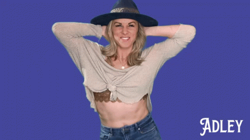A Woman Wearing A Hat And A Sweater Is Named Adley GIF