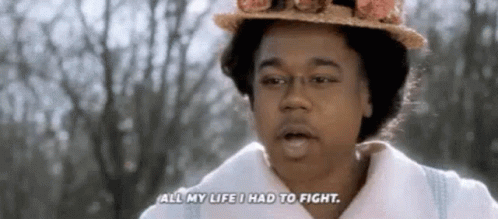 A Woman Wearing A Hat And A White Coat Is Talking About Her Life . GIF