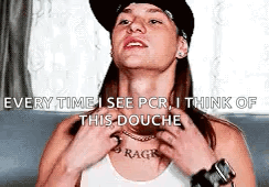 A Woman Wearing A Hat And A White Tank Top Is Looking Up . GIF