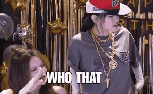 A Woman Wearing A Hat And Gold Chains Says Who That GIF