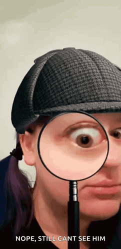 A Woman Wearing A Hat Is Holding A Magnifying Glass To Her Eye GIF