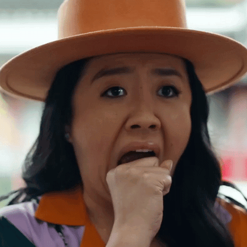 A Woman Wearing A Hat Is Making A Funny Face GIF