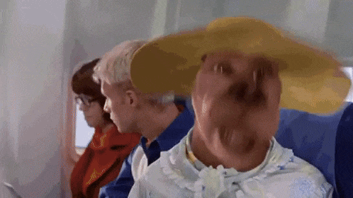 A Woman Wearing A Hat Is Sitting On A Plane GIF