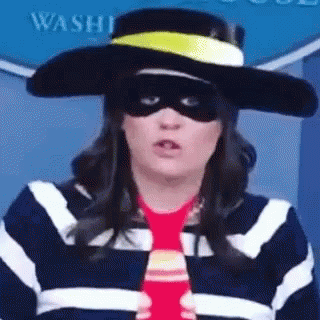 A Woman Wearing A Hat , Mask , And Tie . GIF