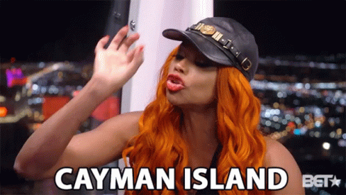 A Woman Wearing A Hat Says Cayman Island GIF