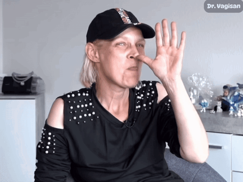 Woman With Hat Saying Dr. Vagisan To Nose GIF