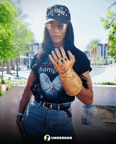A Woman Wearing A Hat That Says Las Vegas Holds Up A Glove GIF