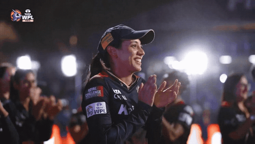 A Woman Wearing A Hat That Says Royal Challenge GIF