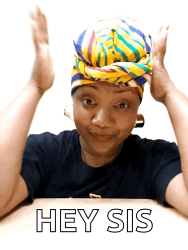 A Woman Wearing A Head Scarf Is Sitting At A Table And Says Hey Sis GIF