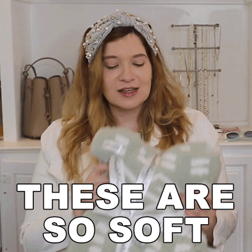 A Woman Wearing A Headband And A White Jacket Says These Are So Soft GIF