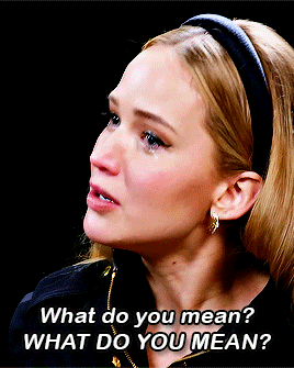 A Woman Wearing A Headband And Earrings Says What Do You Mean GIF