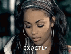 A Woman Wearing A Headband And Hoop Earrings Is Making A Face And Saying `` Exactly '' . GIF