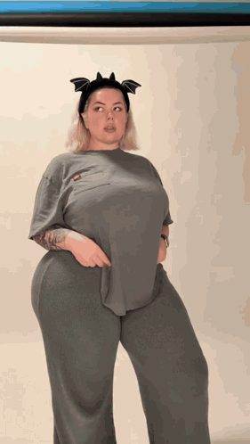 A Woman Wearing A Headband With Bats On It GIF