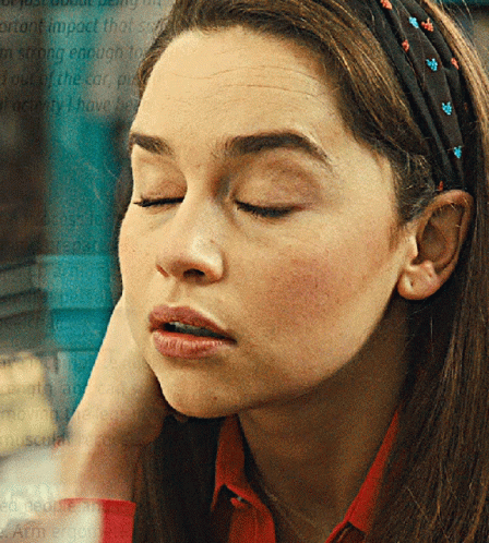 A Woman Wearing A Headband With Flowers On It GIF